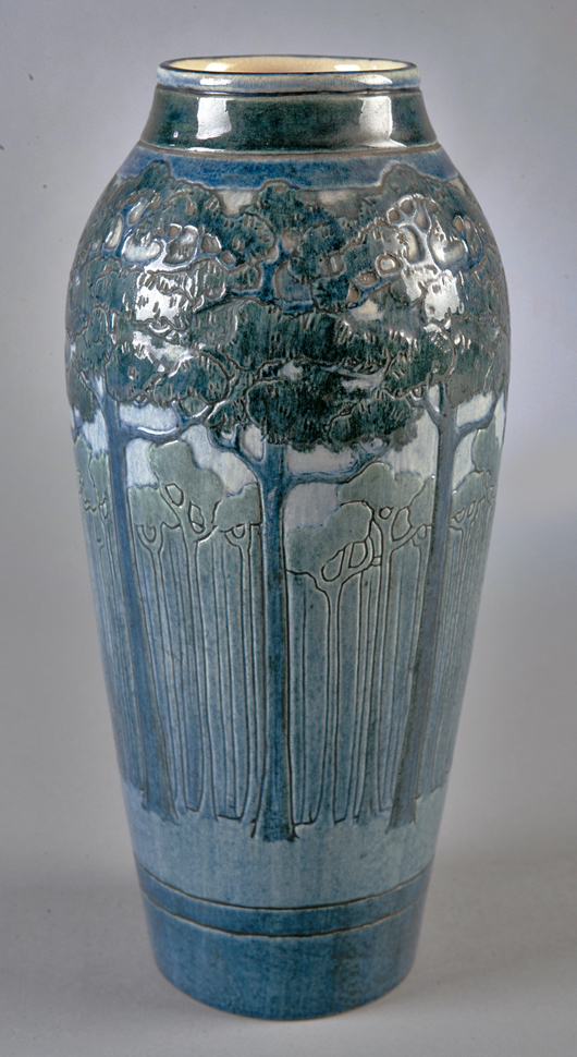 A 1908 high-glaze vase with a circle of pine trees decorated by Leona Nicholson is an excellent example of how carving and modeling was used to add depth to the painted design; this vase doubled its estimate to bring $67,000 in 2007. Courtesy Neal Auction Co.